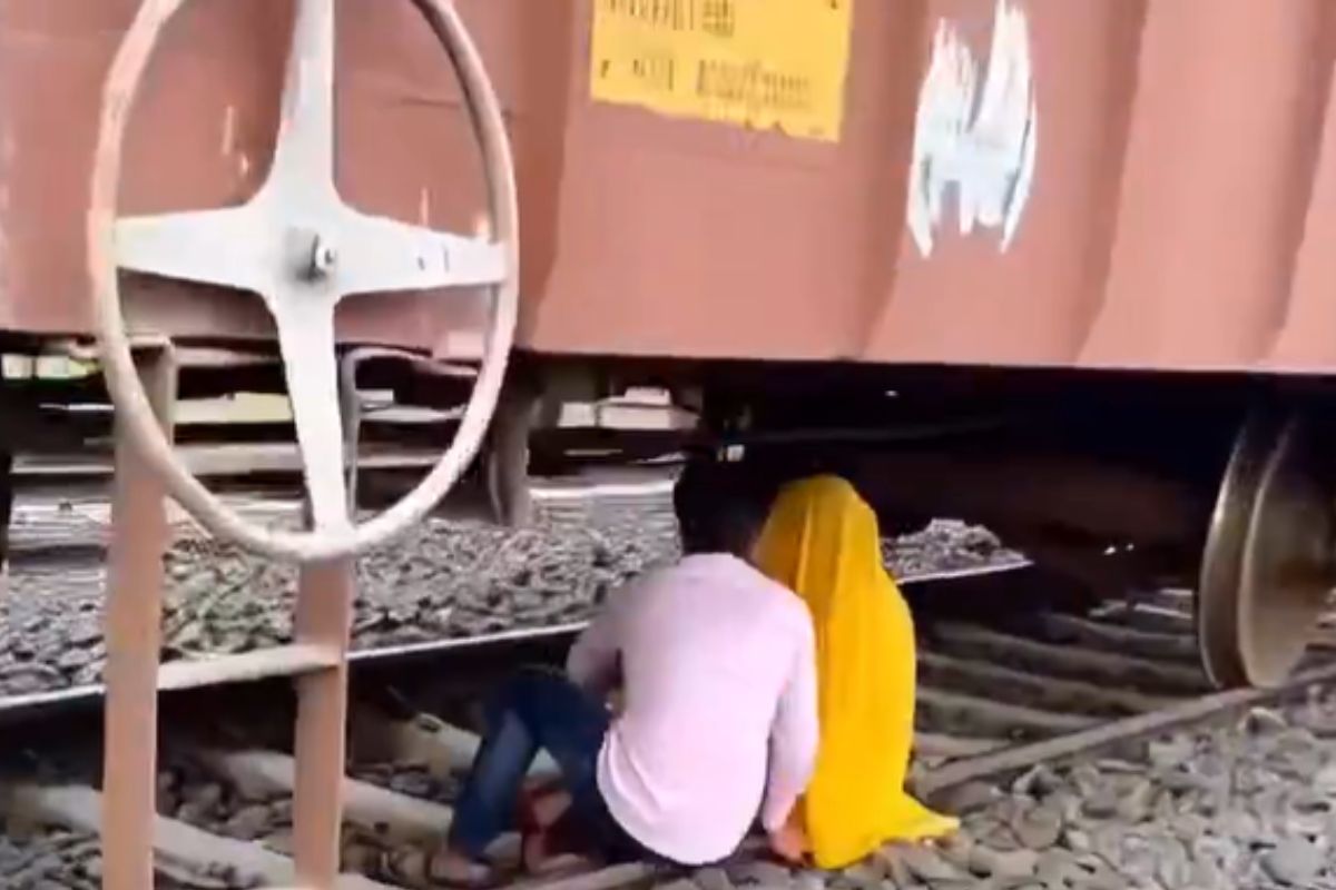 Viral Video Shocks Internet: Young Couple Romancing Under Parked Freight Train Sparks Safety Concerns